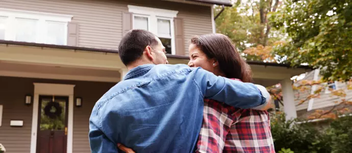 Happy couple outisde of new home