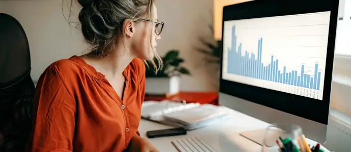 Business woman reviewing a graph on her computer