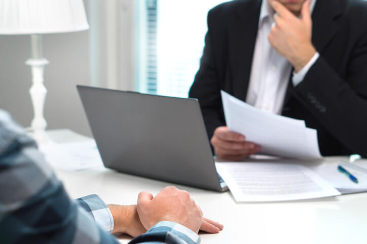 Business person sitting with attorney