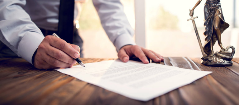 Man signing legal contract