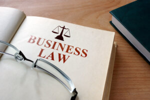 Business Litigation Lawyer Miami, FL - business law book on desk with glasses