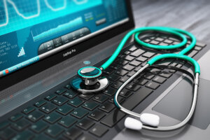 Insurance Claims Lawyer Coral Gables, FL - Laptop with medical diagnostic software and stethoscope