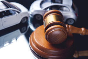 car insurance claim lawyer Coral Gables, FL - Model of car and gavel. Accident lawsuit or insurance, court case