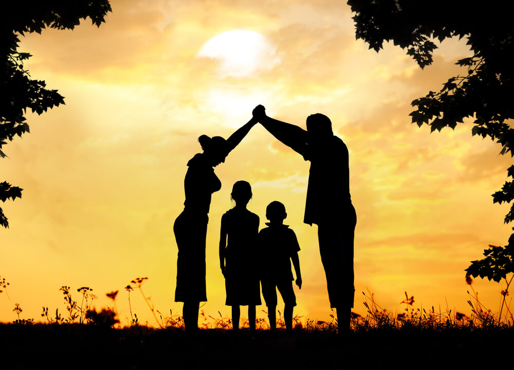 HOA Dispute Lawyer Tampa, FL - Silhouette, group of happy children playing on meadow, sunset