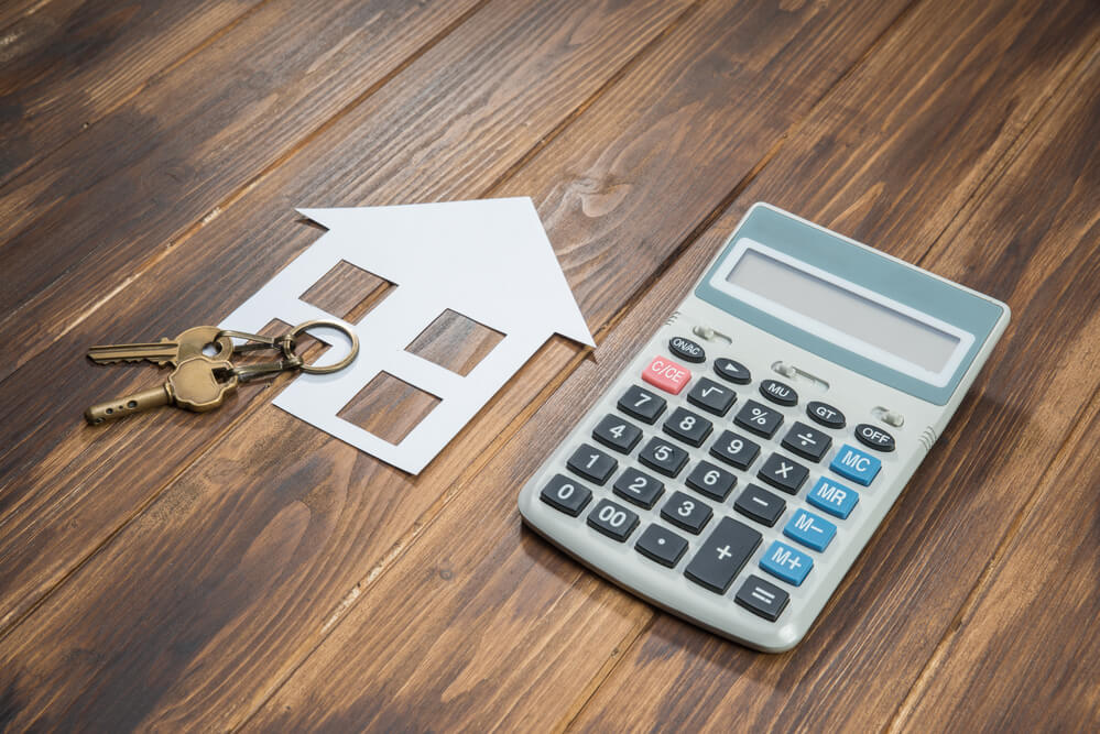 HOA Lawyer Fort Lauderdale, FL-3-house and key with Calculator on wooden background