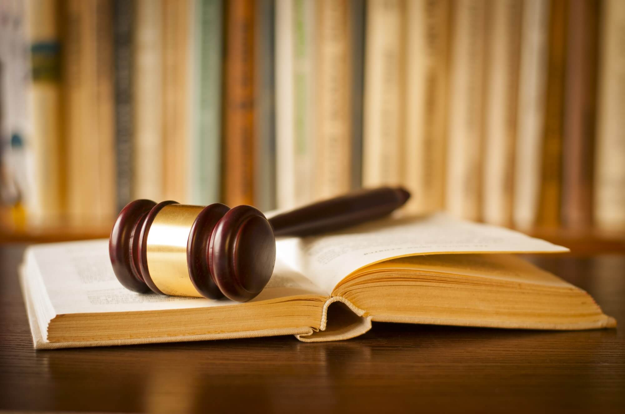 How Can An HOA Dispute Lawyer Help Resolve My Conflict? - gavel rests upon a legal book in legal library